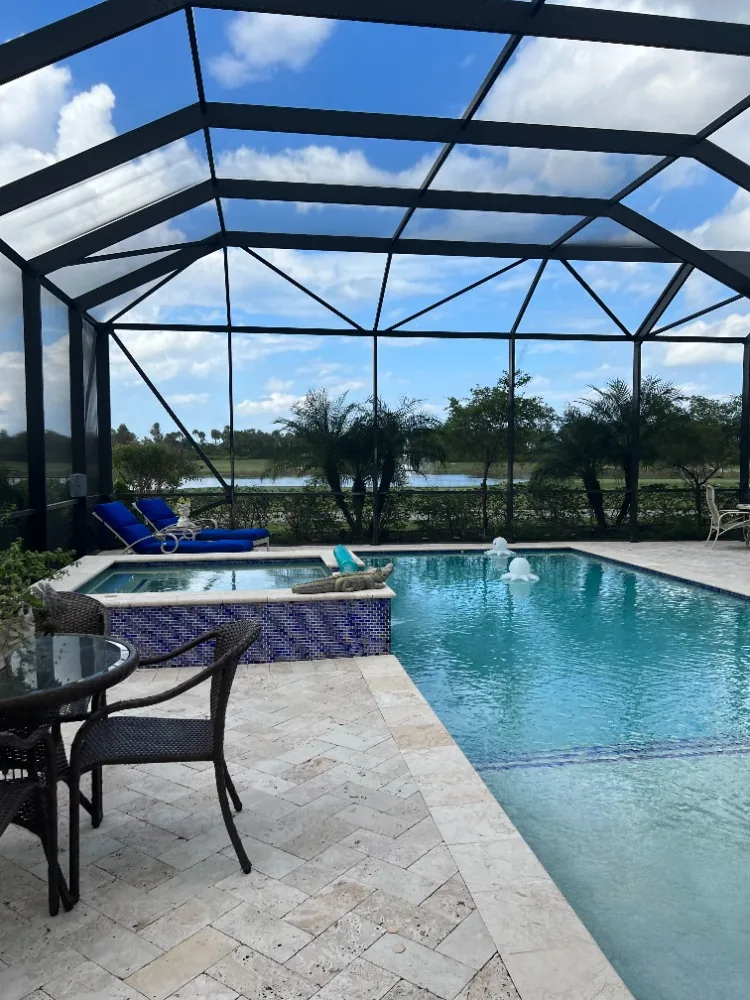 A rescreened pool cage over a spa and pool